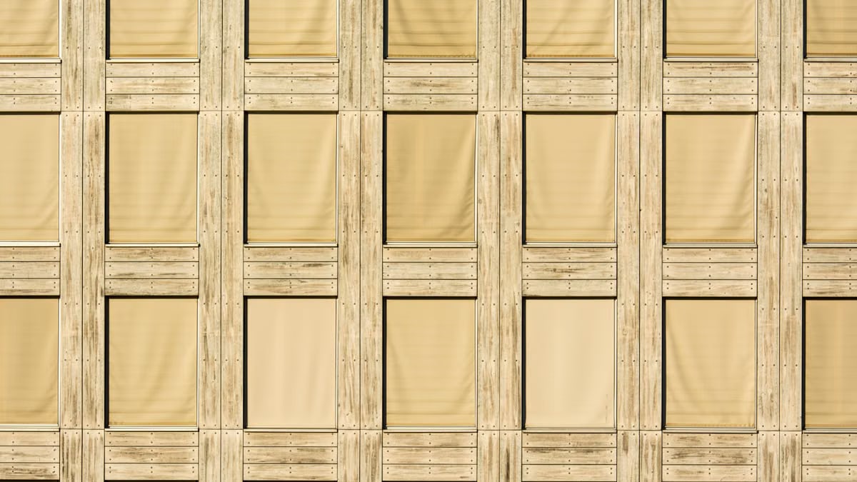 Architectural detail of a modern building facade with wooden paneling and geometric patterns.